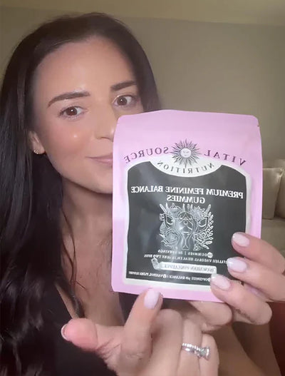 Happy customer holding Lumèra gummies